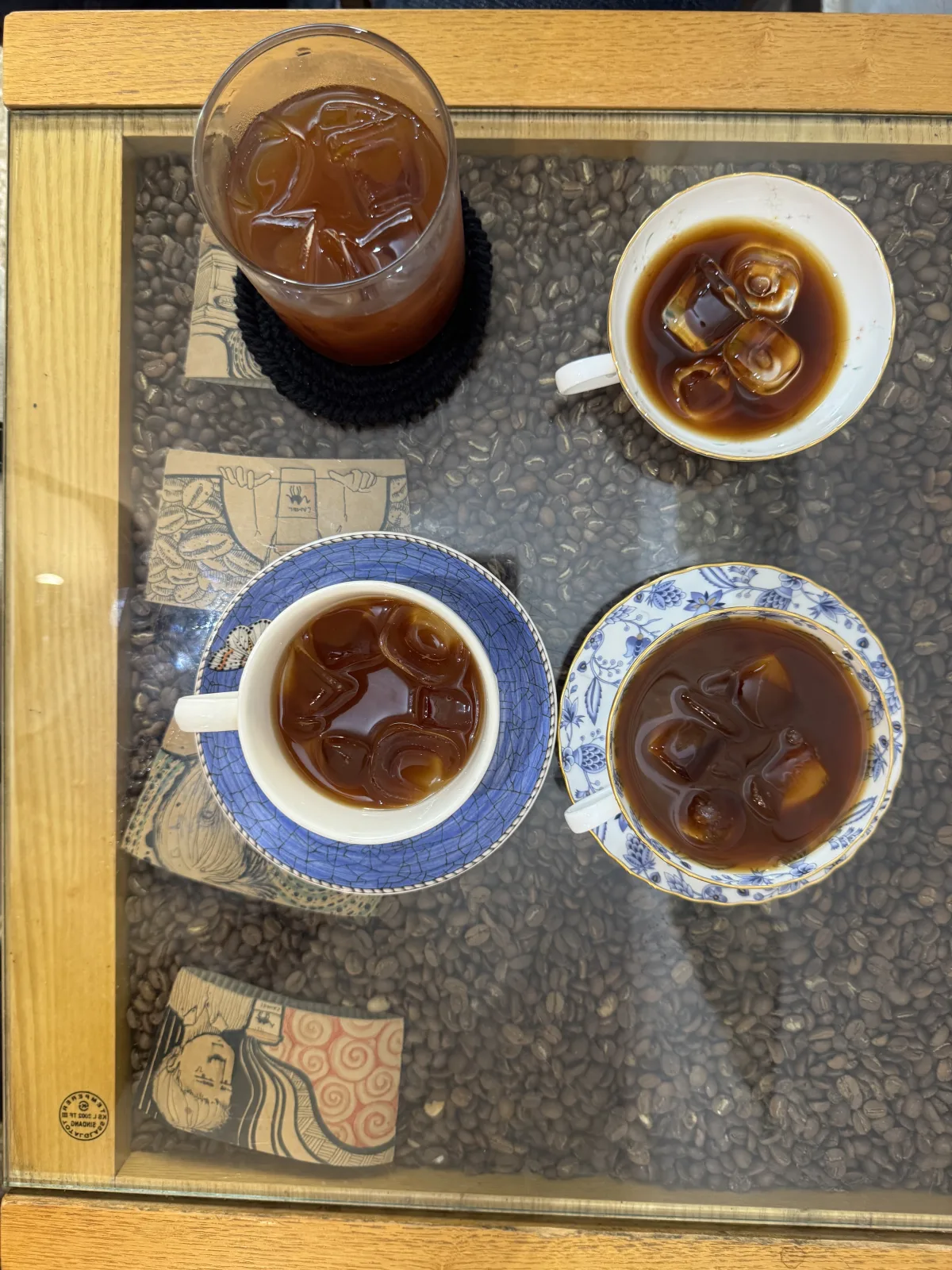 Four iced coffees served in different cups at Nakta Coffee Roasters