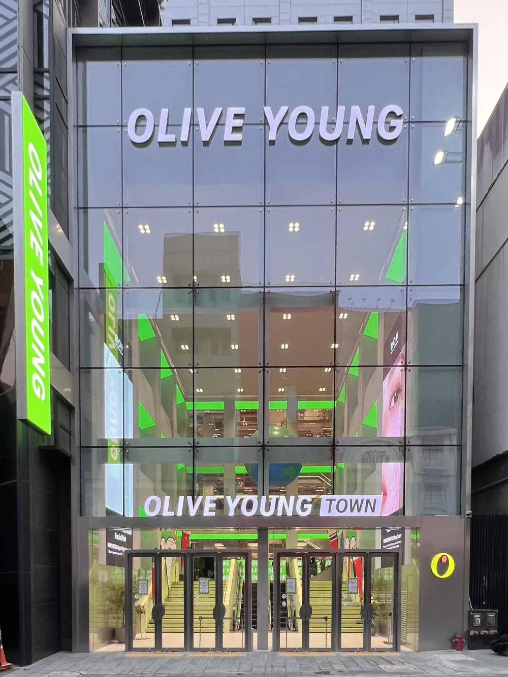 The three-story glass facade of Olive Young Central Myeongdong Town